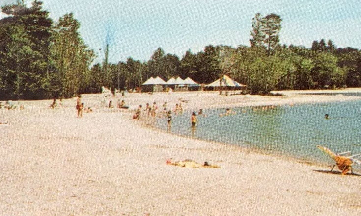 Point Sebago Resort postcard image showing the beach and Sebago Lake at Maple Cove, Maine in 1970.