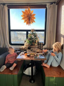 Kids decorating for Christmas in the RV.