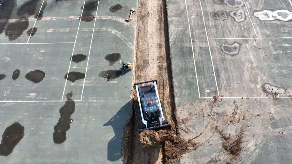 Bobcat tearing up the old sports courts and pushing around dirt at Point Sebago Resort in November 2024.