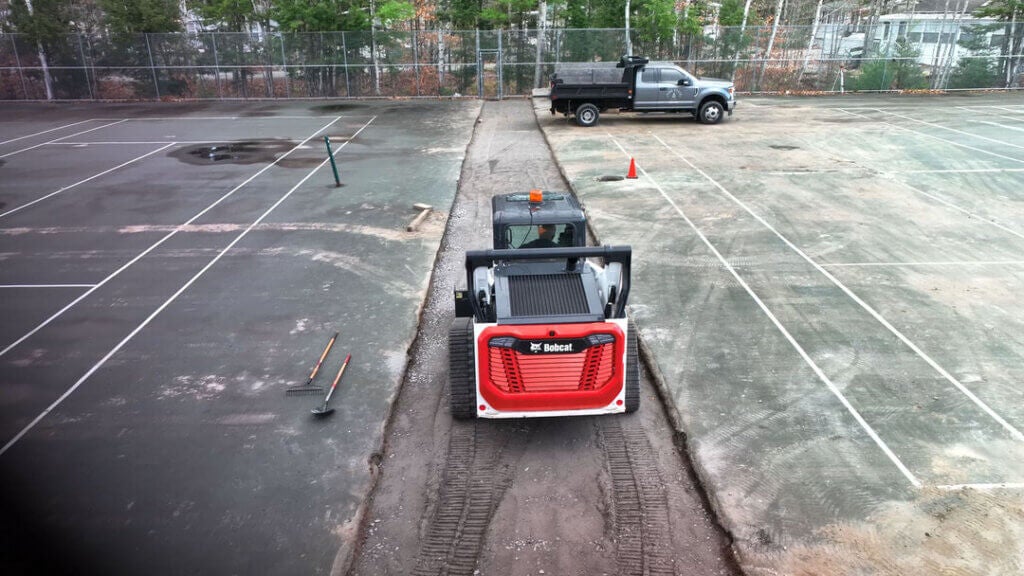 Bobcat tearing up the old sports courts at Point Sebago Resort in November 2024.