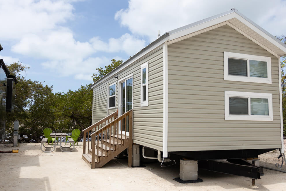 Vacation rental at Big Pine Key RV Park in Florida with a picnic table and chairs on the exterior.