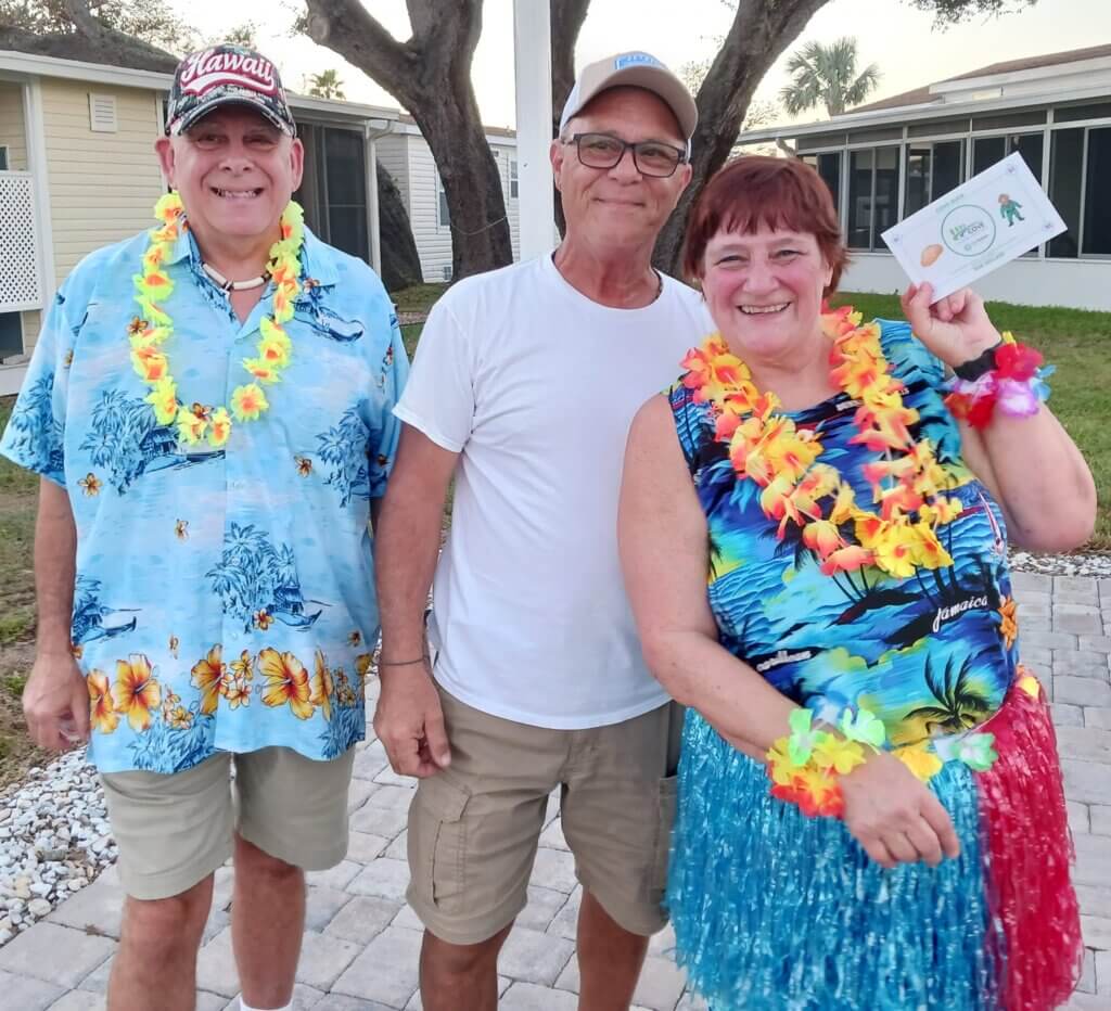 Ray Bonello (center) and Deb Huettner (right) enjoying time with another resident (left) during a community event at The Meadows.