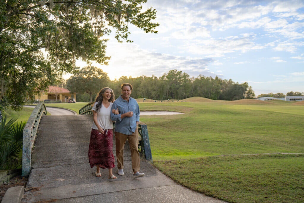 Couple walking along the Big Cypress Golf Club course in Lakeland, Florida.