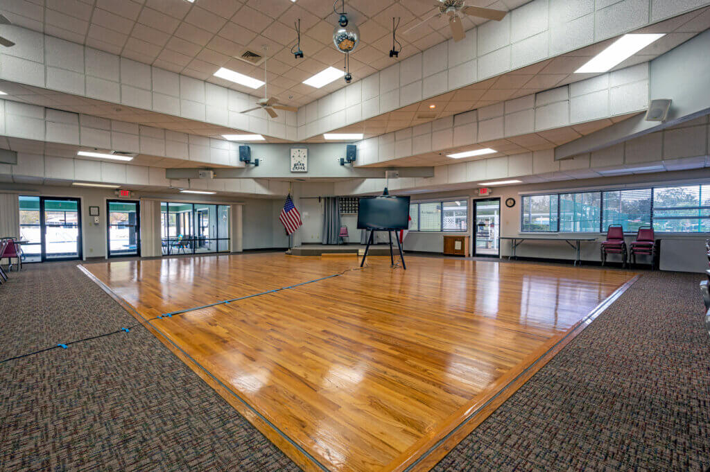 One of three clubhouses at Bear Creek Village, set up for an event with a wood dance floor under the disco ball