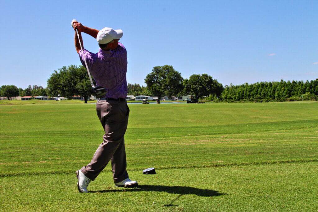 Man teeing off at Big Cypress Golf Club in Lakeland, Florida