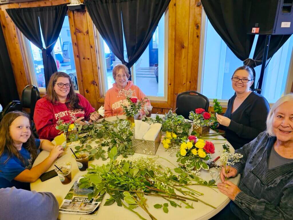 Mothers and daughters making floral arrangements for Mother&#039;s Day at Point Sebago Resort in Maine.