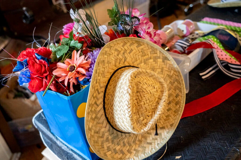 A cowboy hats and craft supplies including ribbons and flowers.