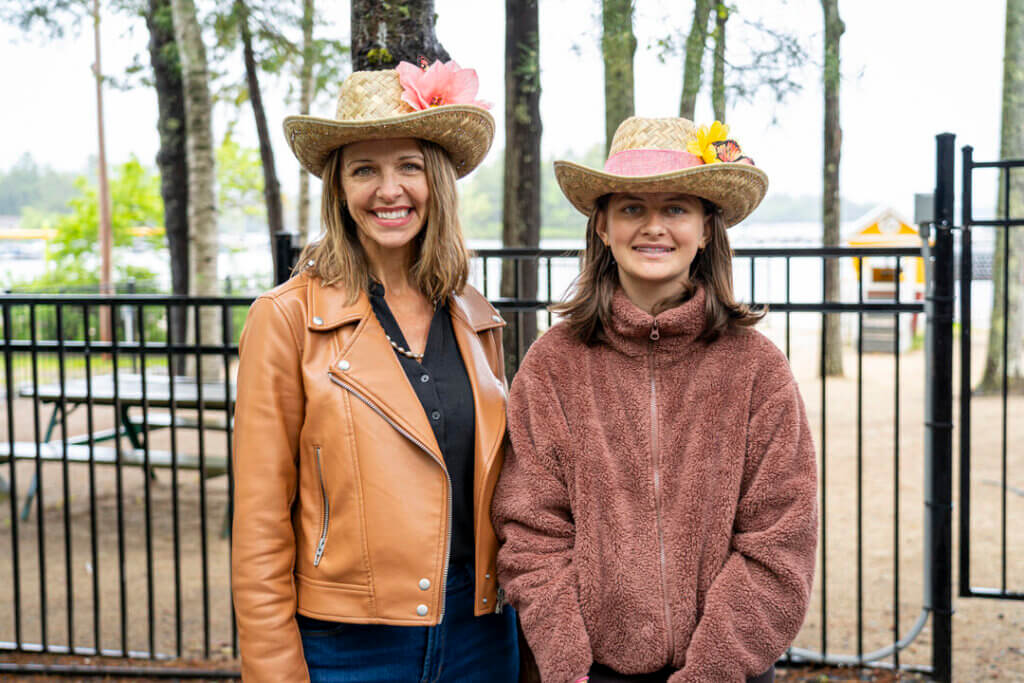 Two women showing off their cowboy hats they crafted at Point Sebago Resort.
