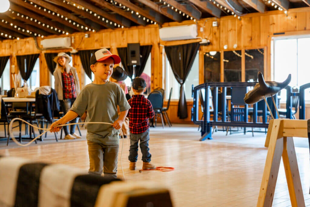 A boy swinging his lasso around at Point Sebago Resort during Country Western Weekend.