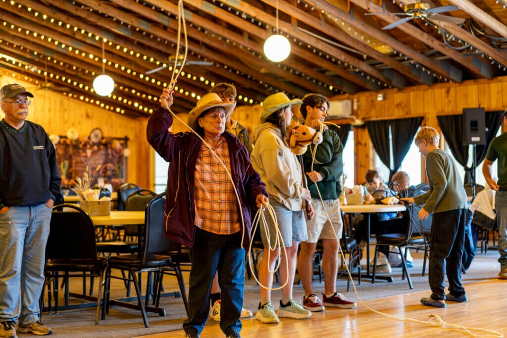 Guests learning to lasso at Point Sebago Resort during Country Western Weekend.