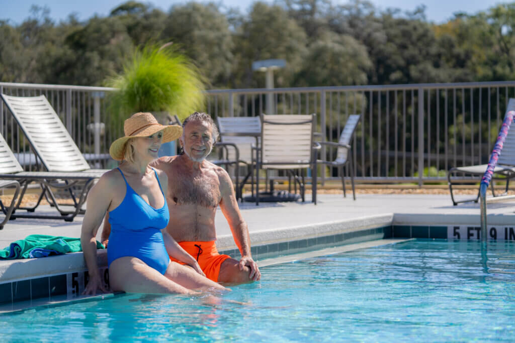 Couple sitting in the swimming pool at Rolling Greens Village in Ocala, Florida.