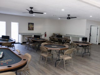 Poker table and poker chips in the fully renovated main room within the West Clubhouse at Rolling Greens Village in Ocala, Florida.