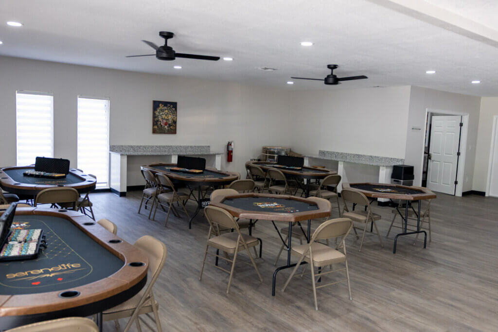 Poker table and poker chips in the fully renovated main room within the West Clubhouse at Rolling Greens Village in Ocala, Florida.
