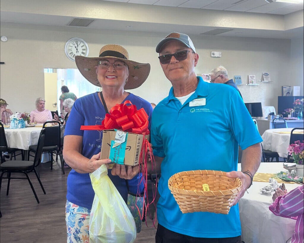 Ray Bonello, the lifestyle manager at The Meadows, poses with a resident at clubhouse event.
