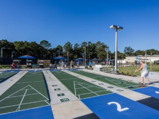 residents playing shuffleboard at the Rolling Greens Shuffleboard Courts