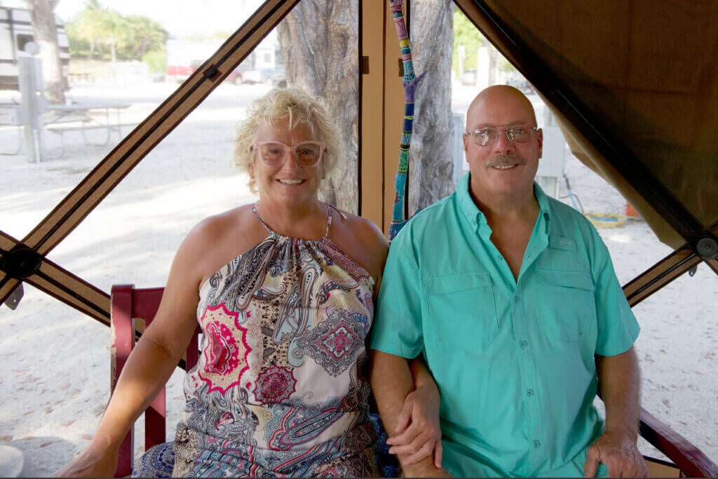 Jill Gawne and Rick Middlebrook sitting outside their RV at Big Pine Key RV Park in Florida.