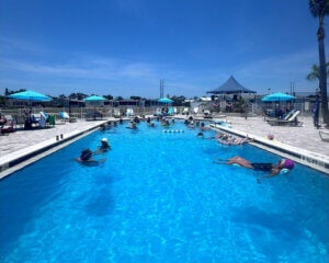 People floating in the swimming pool at The Meadows for a Memorial Day Party in Tarpon Springs, Florida.