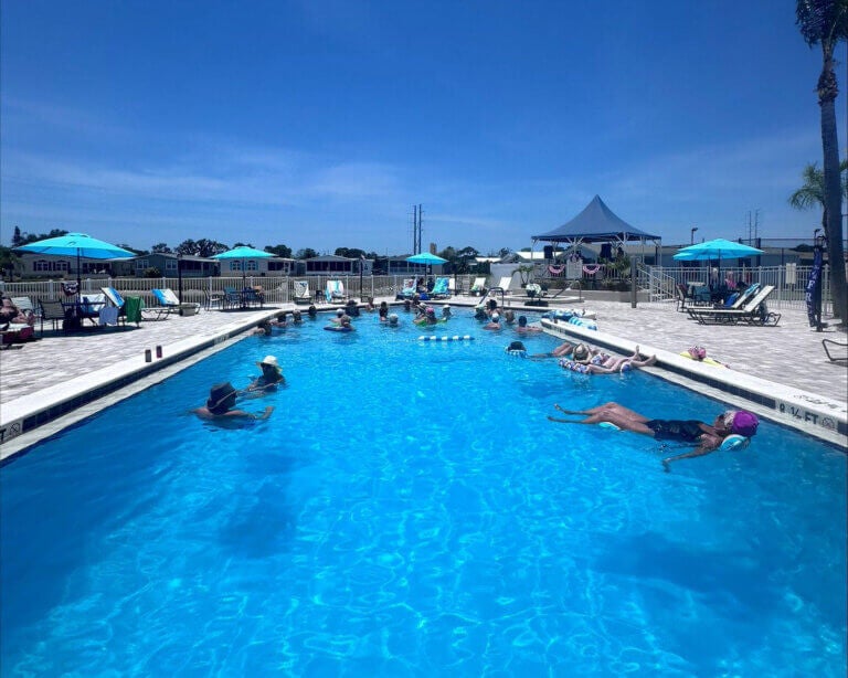 People floating in the swimming pool at The Meadows for a Memorial Day Party in Tarpon Springs, Florida.