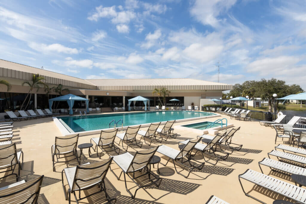 Pool chairs, umbrellas, and cabanas by the Camelot East Village swimming pool and spa