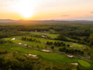 sun setting over the golf course at Point Sebago Resort