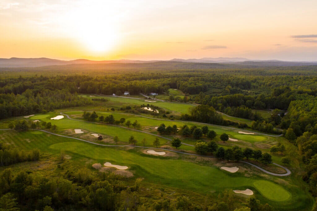 sun setting over the golf course at Point Sebago Resort