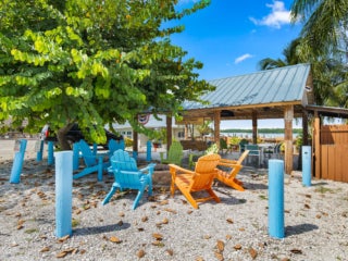 blue and orange chairs surrounding a fire pit