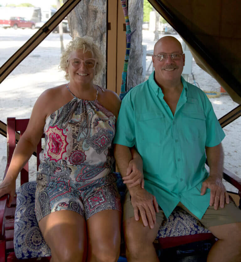 Rick Middlebrooke and Jill Gawne, Big Pine Key Snowbirds, sitting together in their easy up on their RV site
