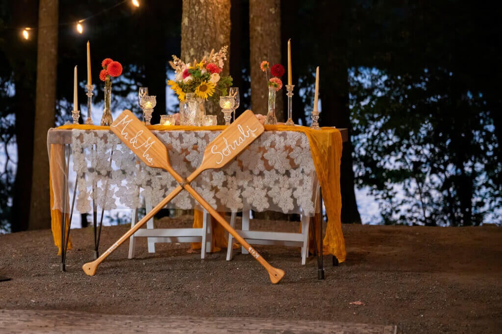 Bridal table with two oars on the shore of Sebago Lake in Casco, Maine. Photo by Life in Focus.