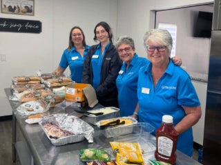 Staff preparing food and drinks in the kitchen at the 2025 RGV West Clubhouse Reopening