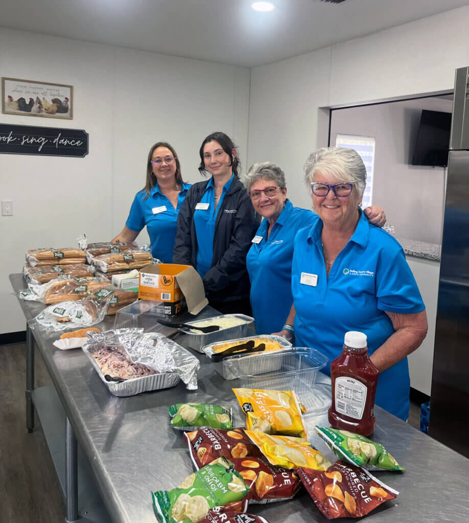 Staff preparing food and drinks in the kitchen at the 2025 RGV West Clubhouse Reopening