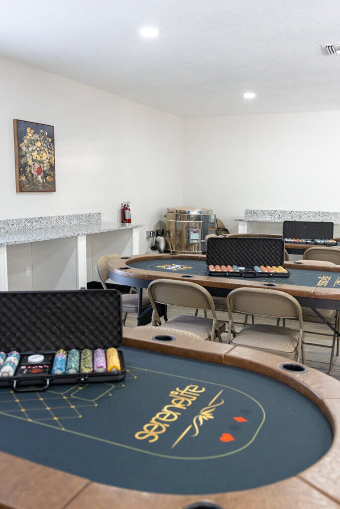 Poker table and poker chips in the fully renovated main room within the West Clubhouse at Rolling Greens Village in Ocala, Florida.