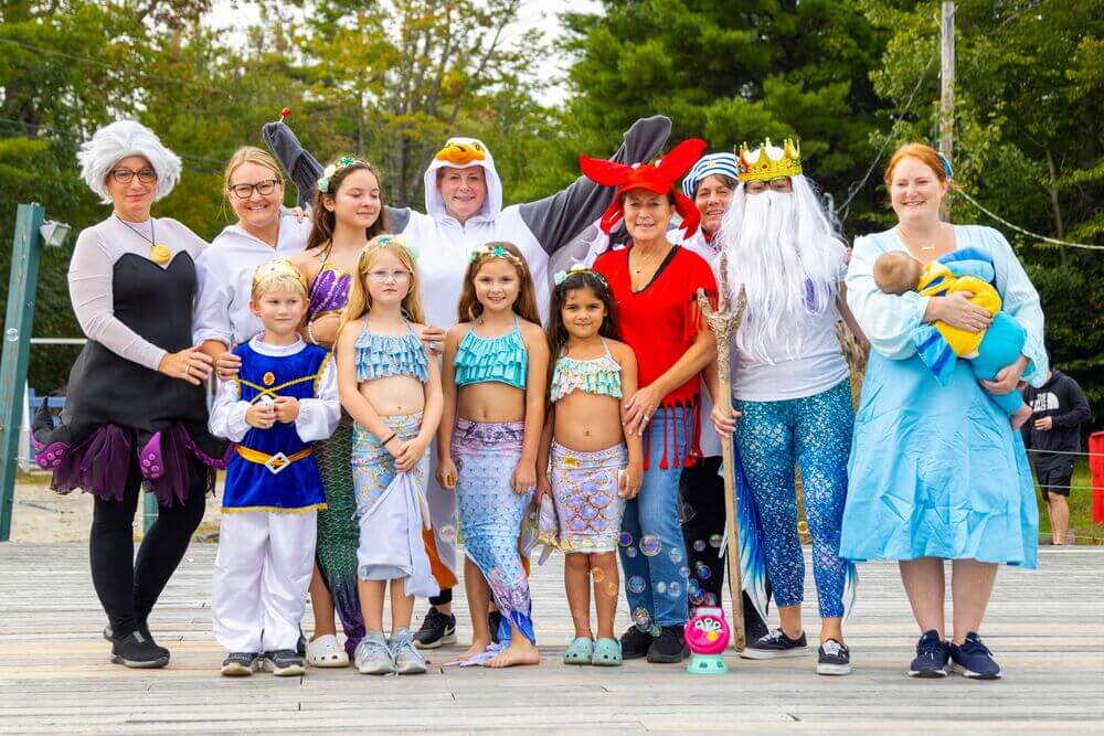Family dressed as the Little Mermaid cast in costumes for Point Sebago Resort Halloween.
