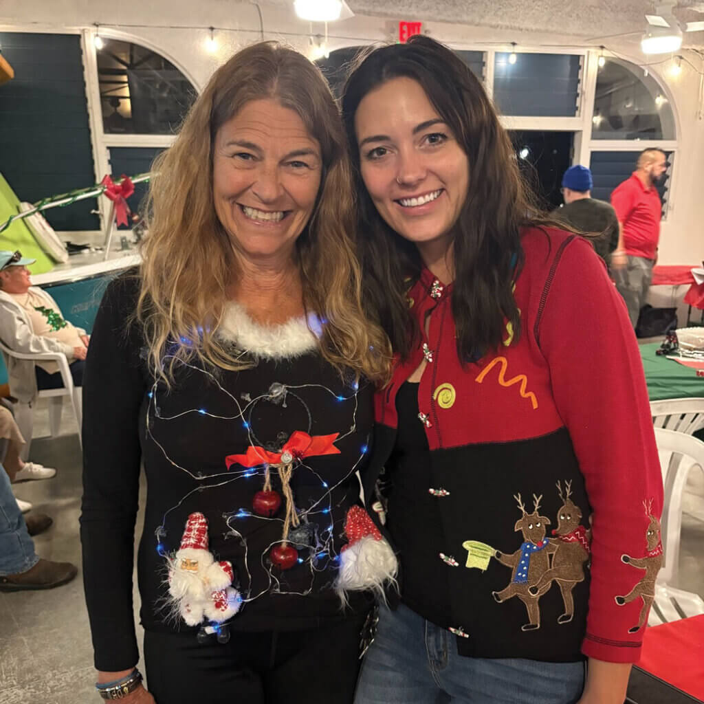 Two guests in ugly Christmas sweaters at Big Pine Key Rv Park in Florida