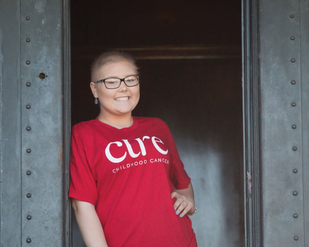 Kylie Shiell wearing a red CURE Childhood Cancer shirt.