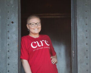Kylie Shiell wearing a red CURE Childhood Cancer shirt.