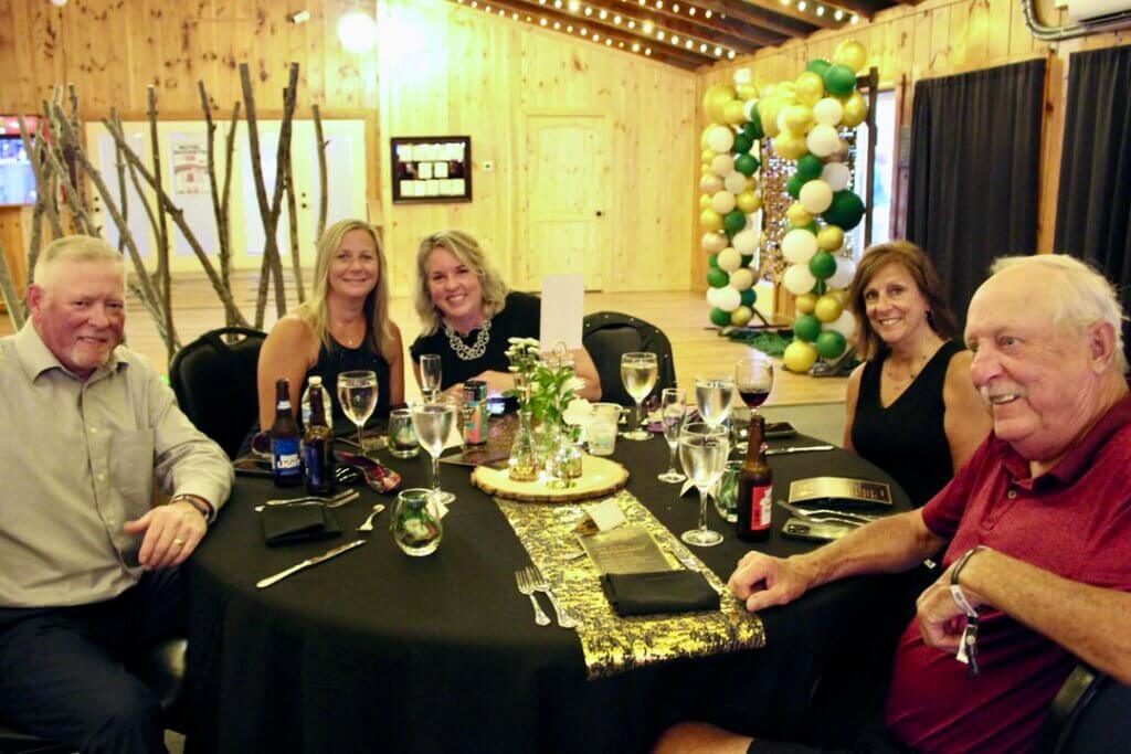 Five people sitting around a table at the Point Sebago Resort Resident&#039;s Choice Awards.