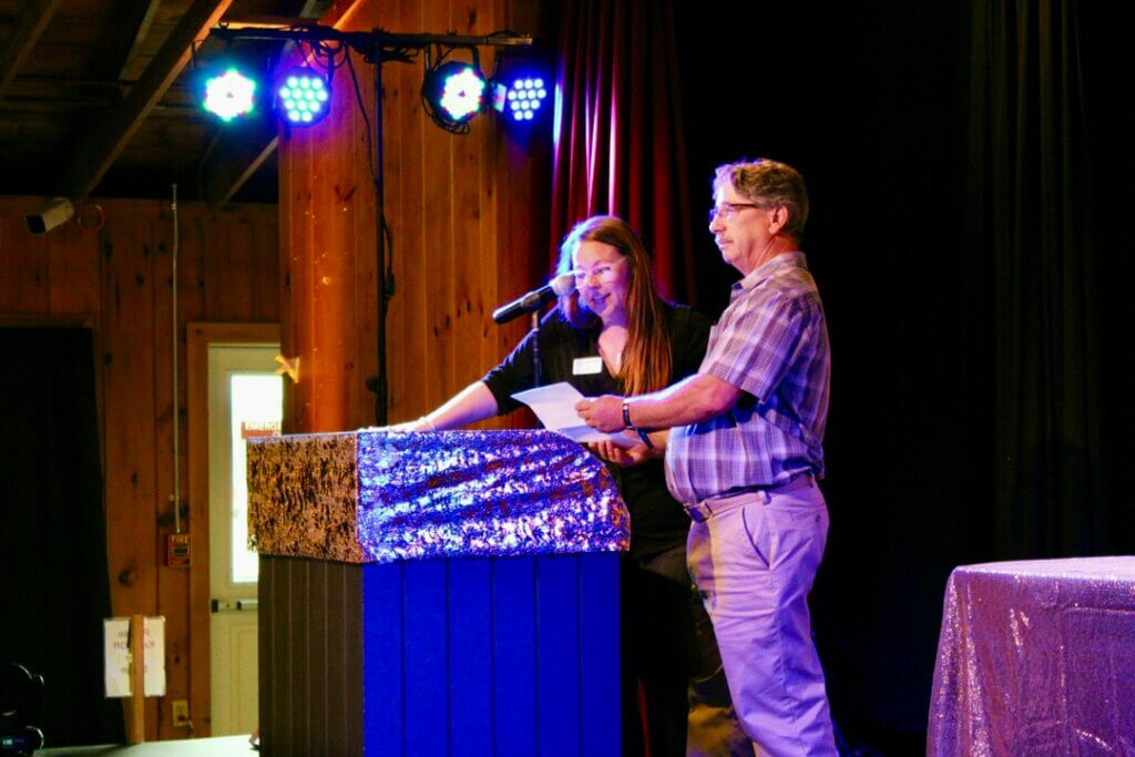 Two people presenting an award at the Point Sebago Resort Resident&#039;s Choice Awards.