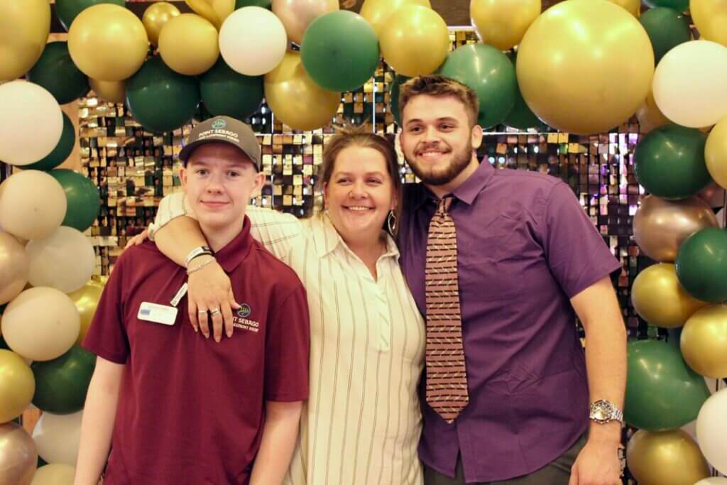 Katie Dailey posing with two people at the Point Sebago Resort Resident&#039;s Choice Awards.