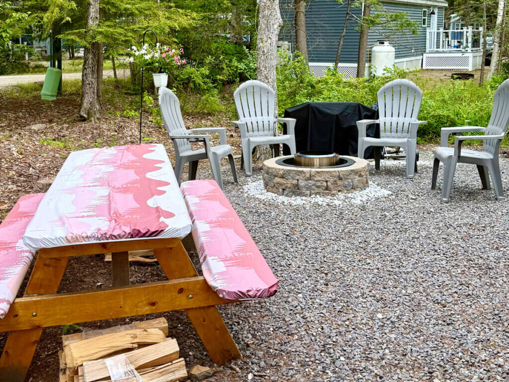 Exterior fire pit of cabin 00754 at Point Sebago Resort on Sebago Lake in Casco, Maine.