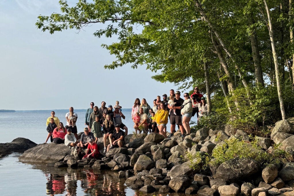 The Caledonia camping crew posing on the rock at Point Sebago Resort in 2025.