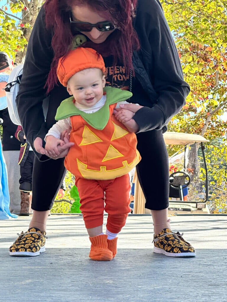 Toddler dressed as a pumpkin in the Halloween Costume Contest at Point Sebago Resort in Casco, Maine.