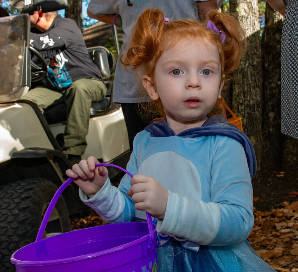 A little girl collecting candy in the Halloween Parade at Point Sebago Resort in Maine. Photo courtesy of Dave Rando Photography.