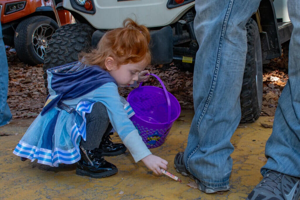 Little girl collecting candy at the Halloween Parade at Point Sebago Resort in Maine. Photo courtesy of Dave Rando Photography.