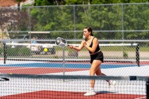 Woman playing pickleball at Point Sebago Resort at the sports complex on Sebago Lake in Maine.