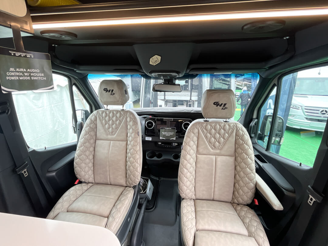 GH1 Tiffin Camper Van In the interior of a Tiffin Camper Van seats are stitched with GH1 logos on the headrests.