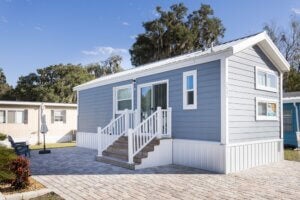 Exterior of a manufactured home (Lot 200G) in Oak Harbor RV Park, located in Haines City, Florida.