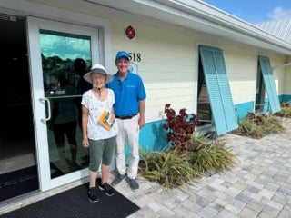 Resident and Cove Communities staff member smiling for a photo at an open house event in Estero Bay Village in Estero, Florida.