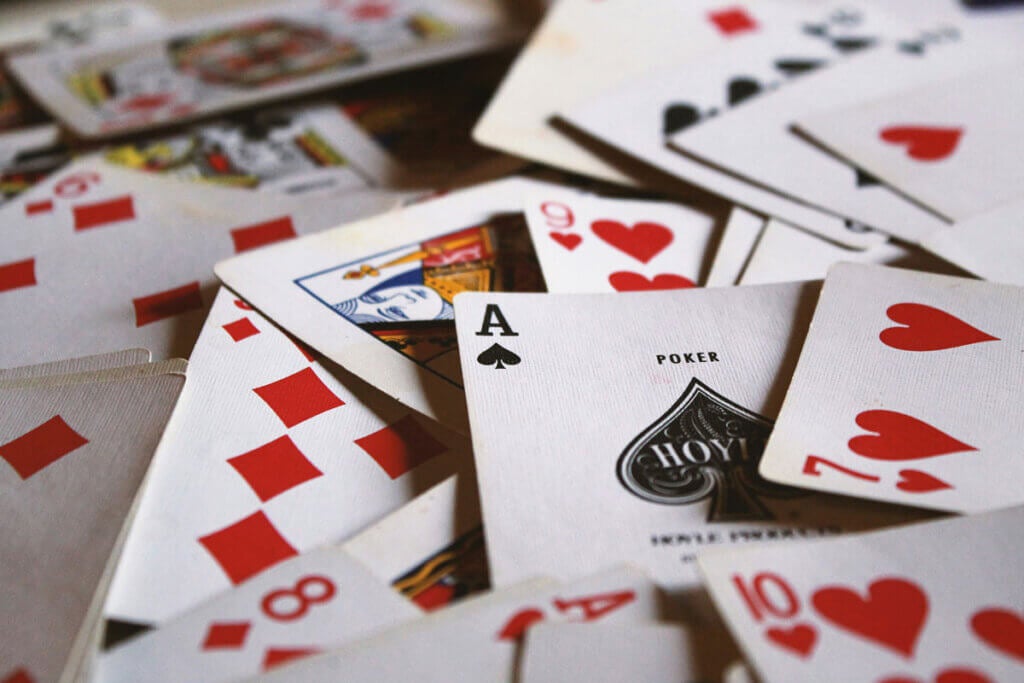 A scattered deck of cards. The ace of spades is the center focus.