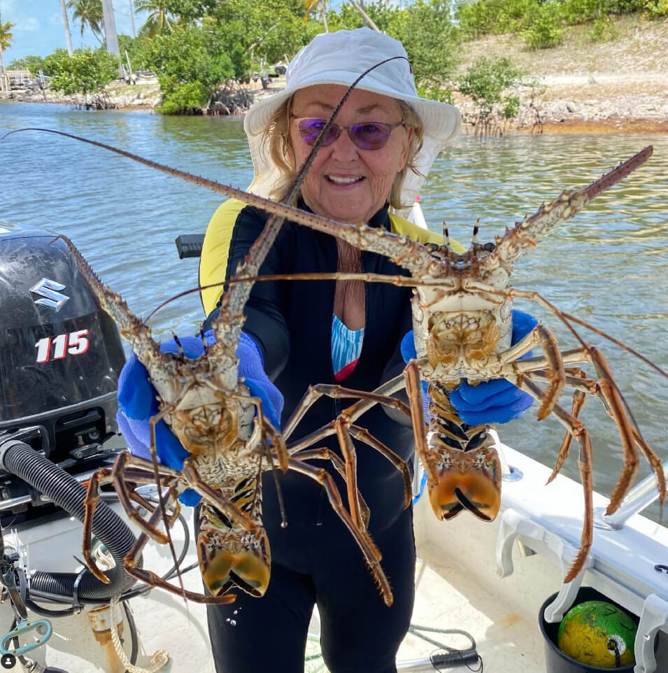 Guest at Big Pine Key holds mini spiny lobster during Mini Lobster season in the Florida Keys