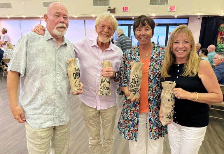 Residents from Camelot East Village in Sarasota, Florida, holding their prizes.